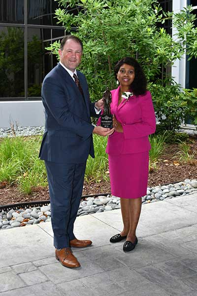 Lorrie Sarver and Bradley Talbert holding The Frist Humanitarian Award.